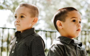 two boys facing away from each other 