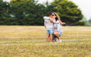 parent and child talking in field