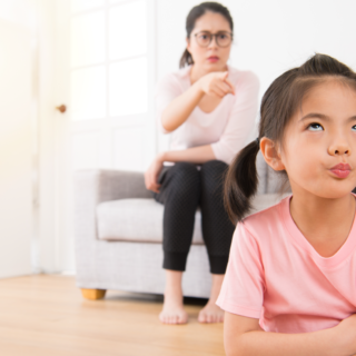 parent pointing at child with arms crossed