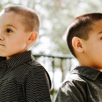 two boys facing away from each other